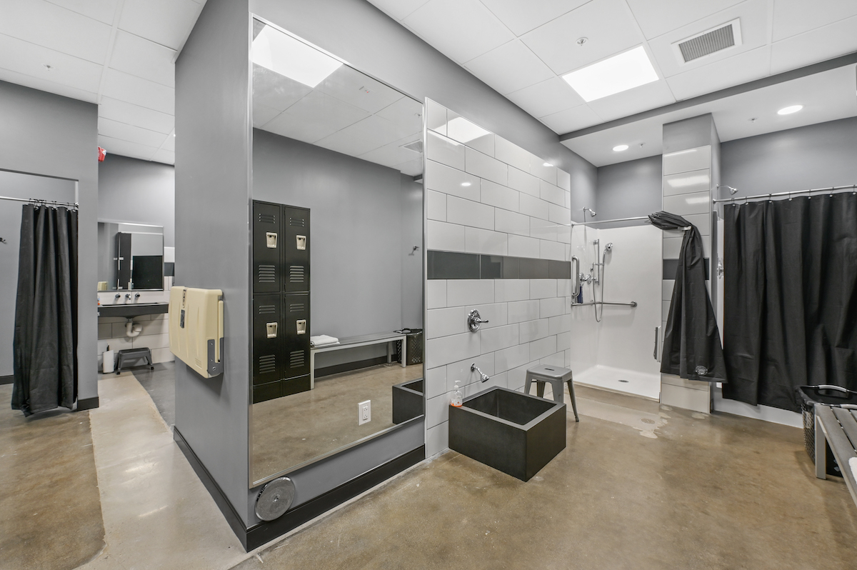 Inside the locker room showing two showers, foot wash station and curtained changing area